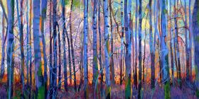 Forest view of young tree trunks in blue shaded light